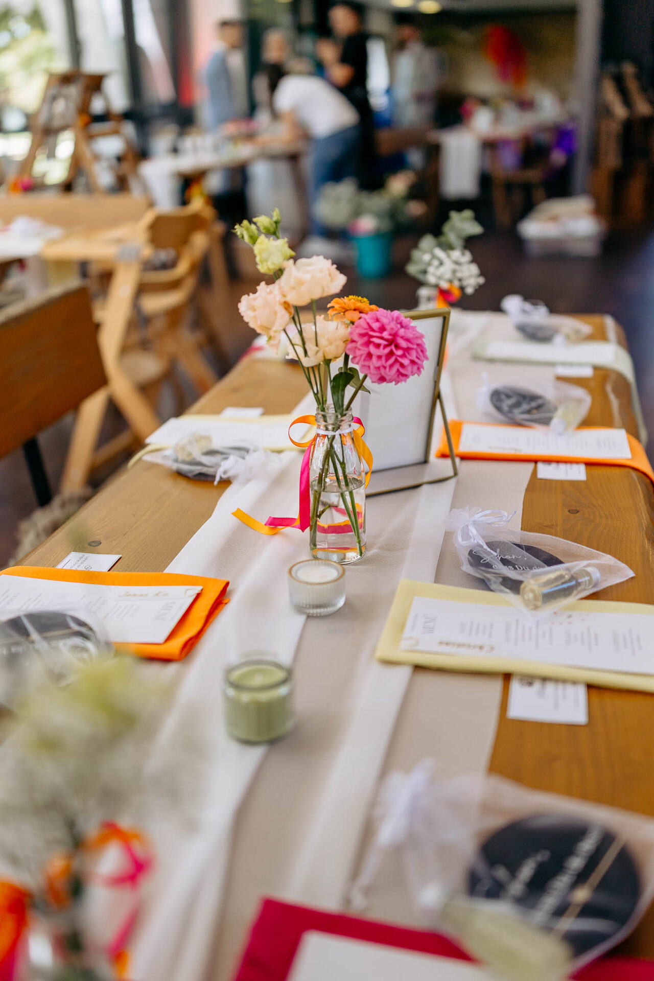 Tischdekoration im Robos Waldblick mit orangen und rosa Blumen