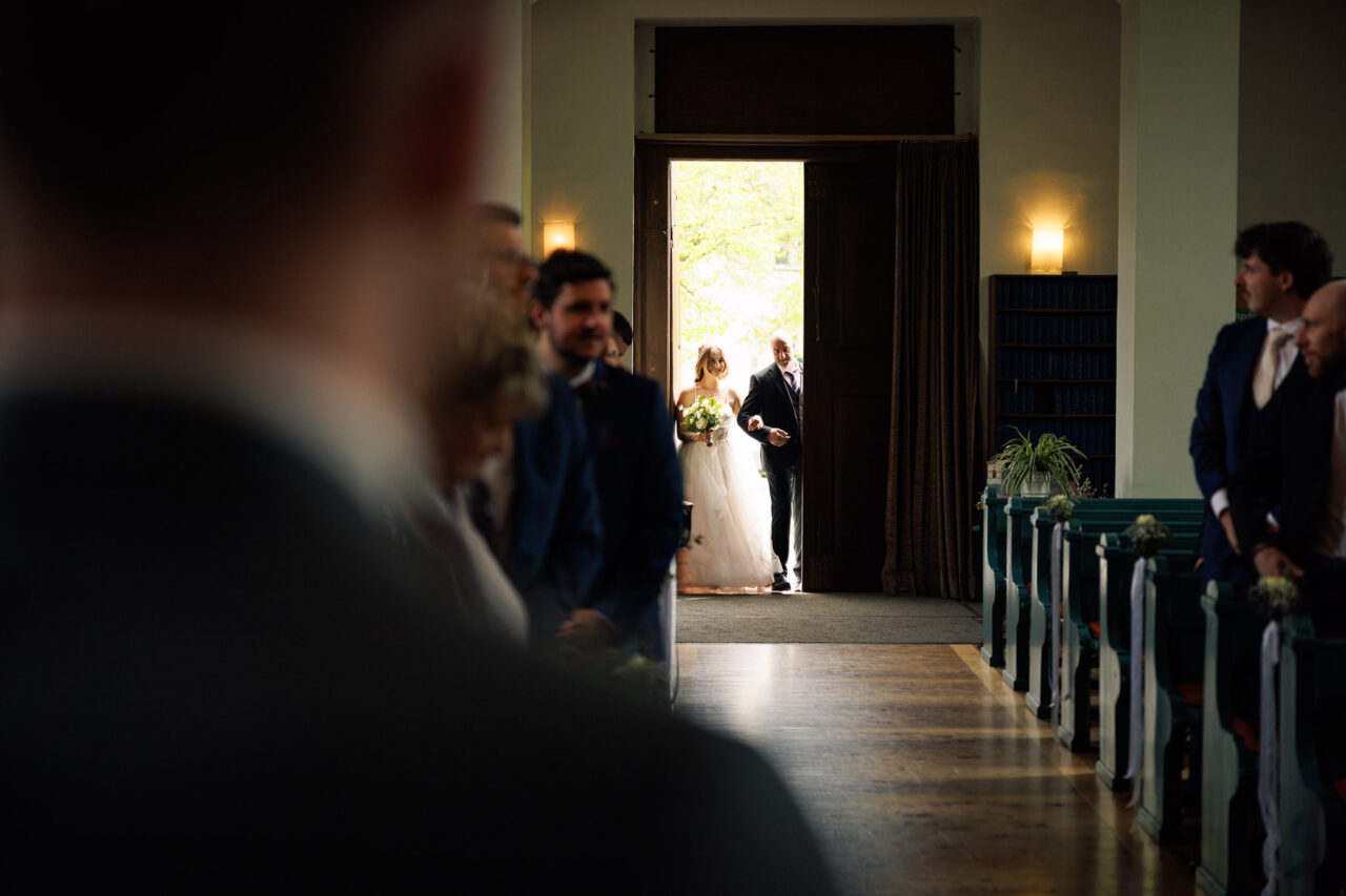 Die Braut wird von ihrem Papa in die Kirche gebracht in dem Moment geht die Tür auf
